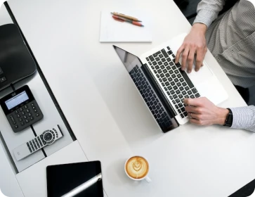 Man typing using laptop in office